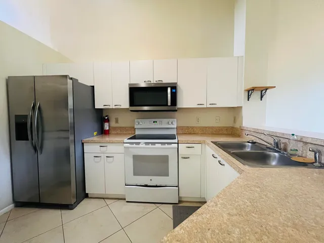 a kitchen with a refrigerator stove and sink