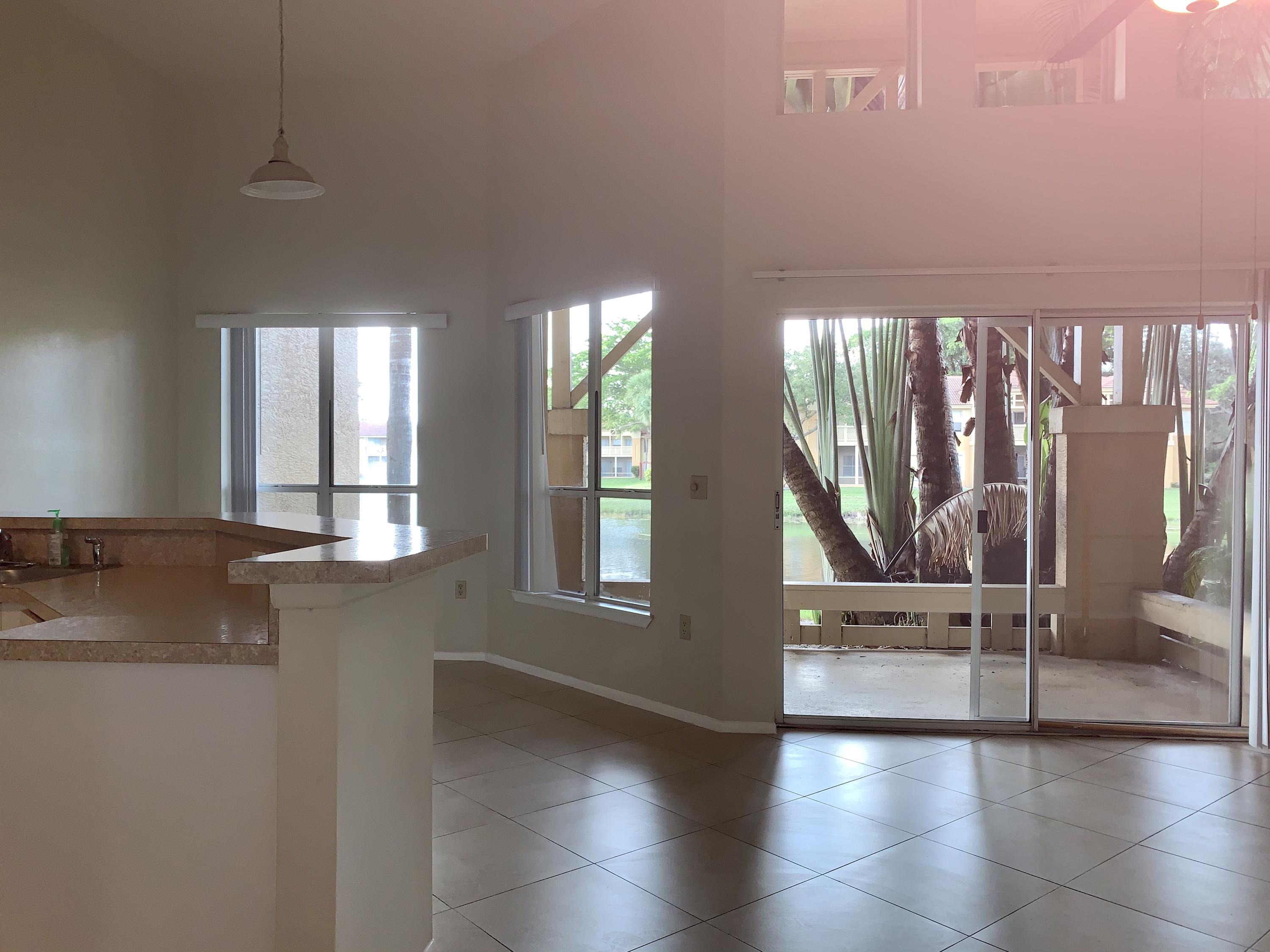 4799 Via Palm Lakes, Unit 1606 West Palm Beach, FL 33417 - Photo 7 of 29 a view of an entryway with wooden floor