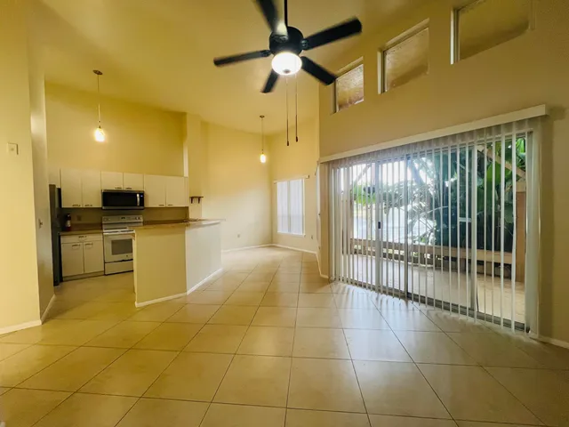 a large kitchen with a stove a refrigerator and a sink