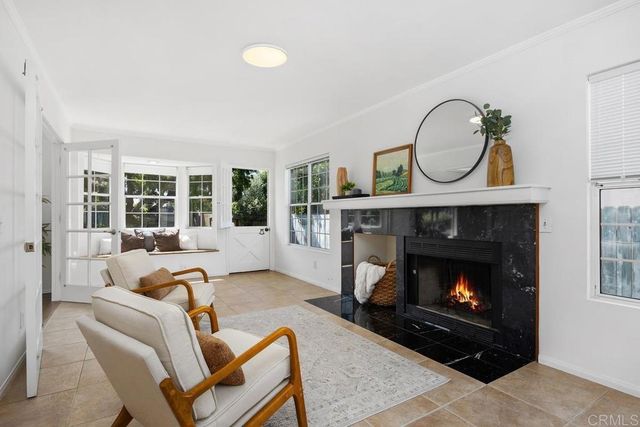 a kitchen with granite countertop a sink stainless steel appliances and white cabinets