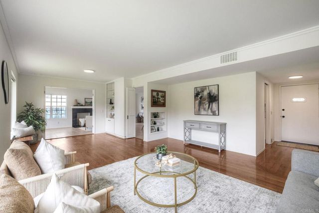 a kitchen with stainless steel appliances granite countertop white cabinets a stove a microwave and a refrigerator