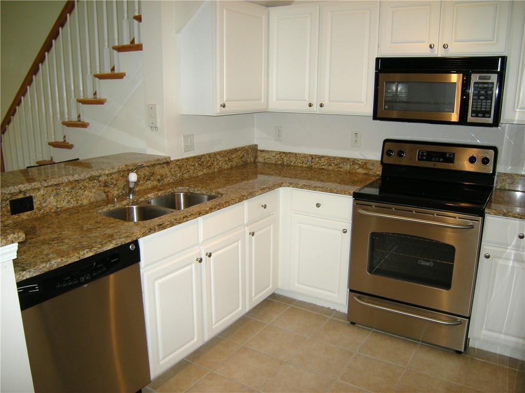 1408 Westchester Ridge Northeast Atlanta, GA 30329 - Photo 4 of 20 a kitchen with granite countertop a stove and a sink