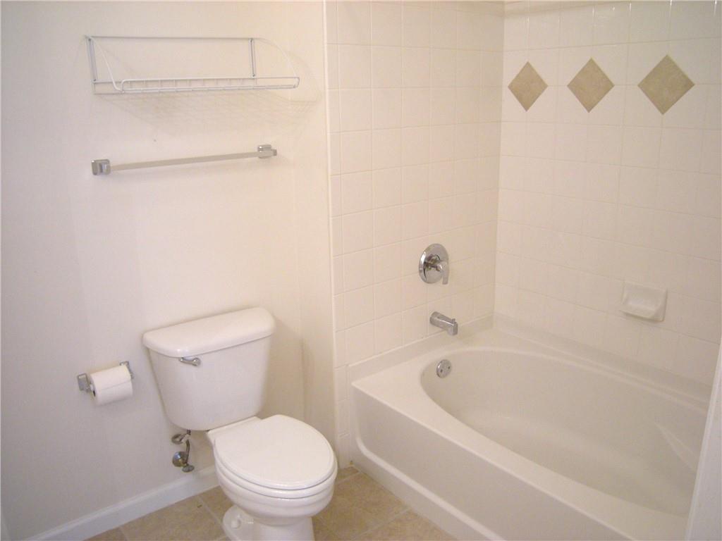 1408 Westchester Ridge Northeast Atlanta, GA 30329 - Photo 10 of 20 a white toilet sitting next to a bath tub