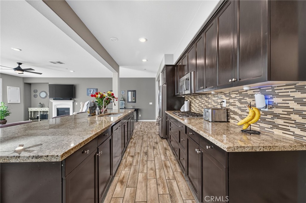 23347 Crystal Way Wildomar, CA 92595 - Photo 19 of 109 a kitchen with kitchen island granite countertop a sink counter top space and cabinets