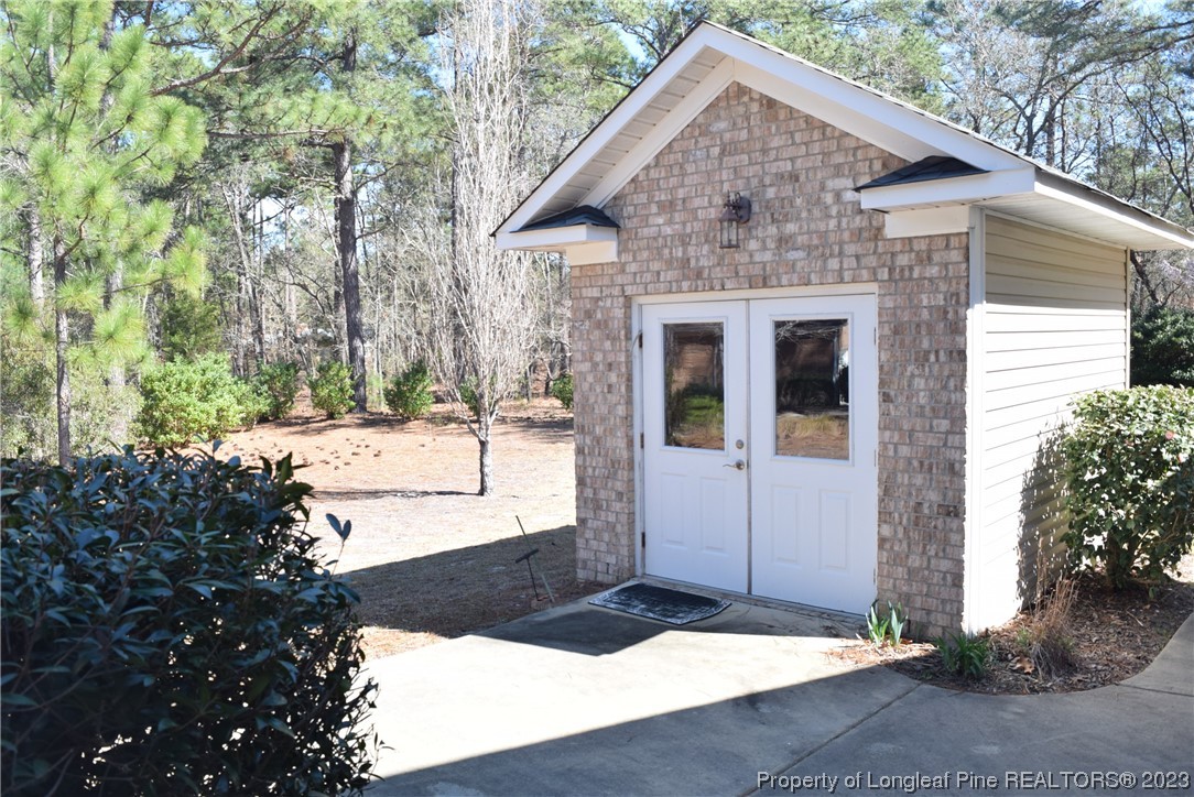 249 Rothbury Drive Whispering Pines, NC 28327 - Photo 21 of 26 a front view of a house with a yard