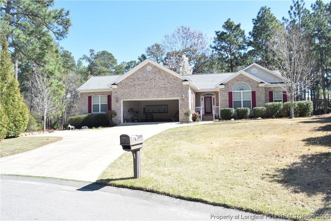 249 Rothbury Drive Whispering Pines, NC 28327 - Photo 26 of 26 a front view of a house with a yard