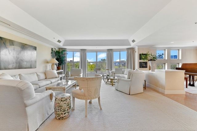 a living room with fireplace furniture and a large window