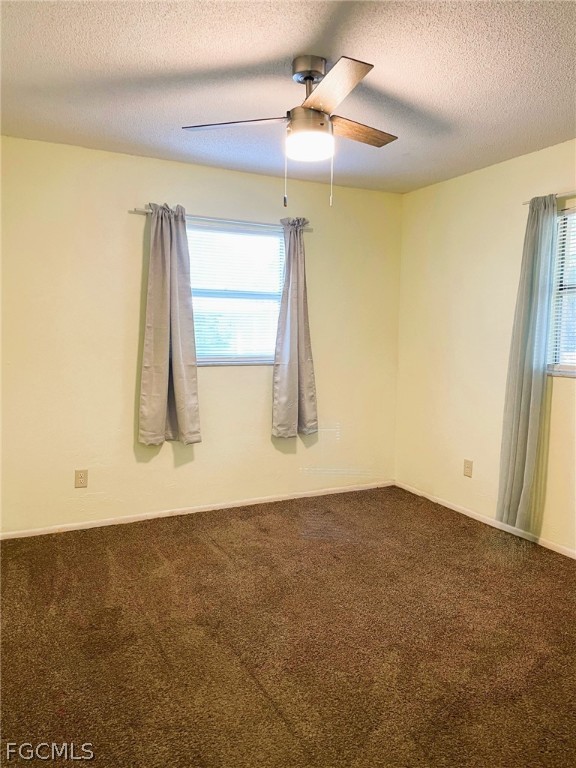 7365 Coon Road North Fort Myers, FL 33917 - Photo 5 of 12 a view of a room with wooden floor and a ceiling fan