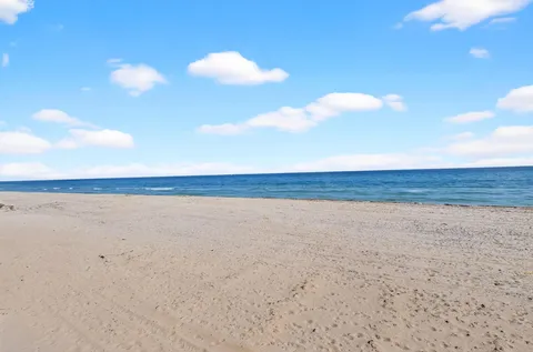 a dining room with furniture and a floor to ceiling window