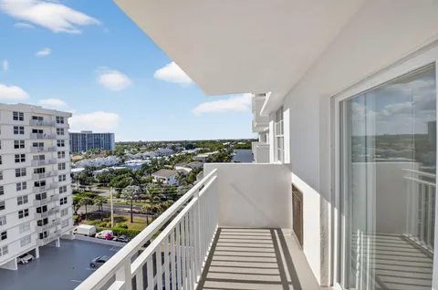 a living room with furniture kitchen view and a wooden floor