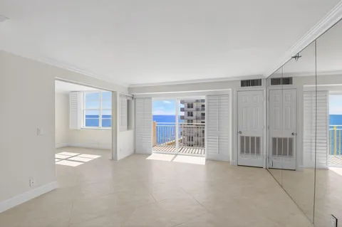 a view of room with window and a ceiling fan