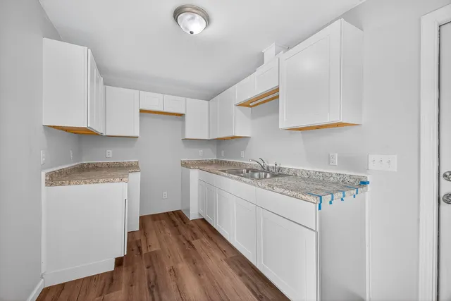 a kitchen with a sink stove and cabinets