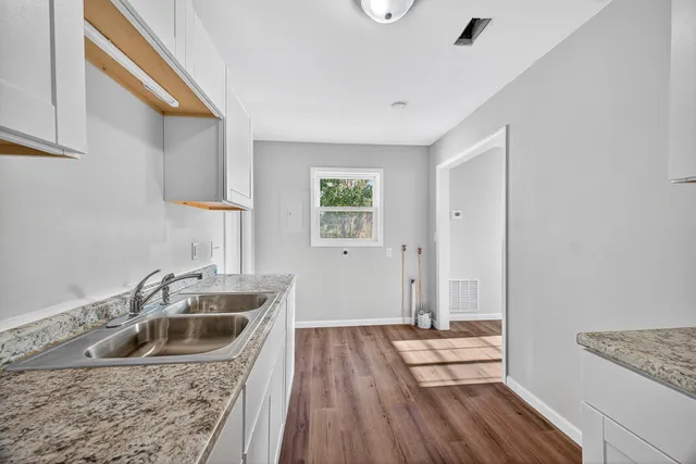 a kitchen with a sink and refrigerator