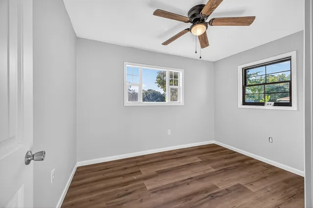 wooden floor in an empty room with a window