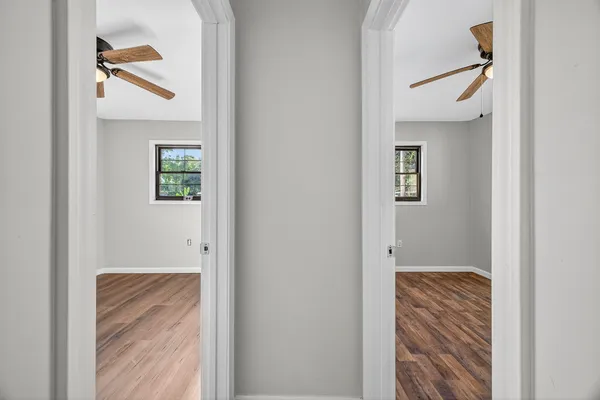 a view of hallway with windows and stairs