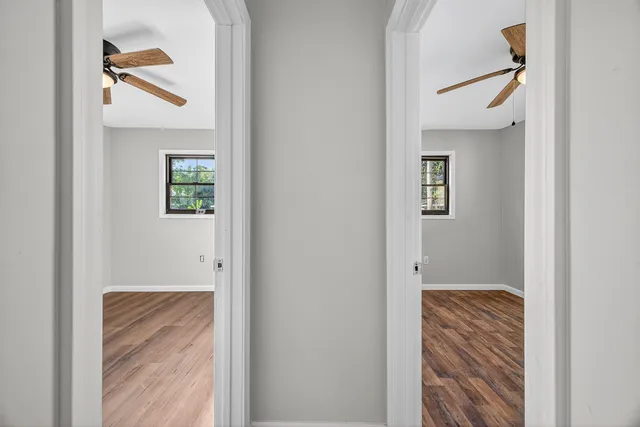a view of hallway with windows and stairs