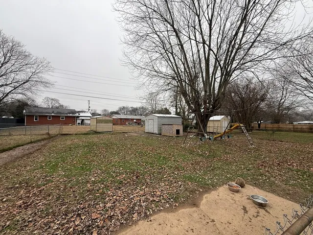 a backyard of a house with yard barbeque oven and outdoor seating