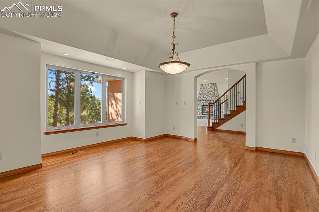 810 Dolan Drive Monument, CO 80132 - Photo 13 of 50 a view of an empty room with wooden floor fan and a window