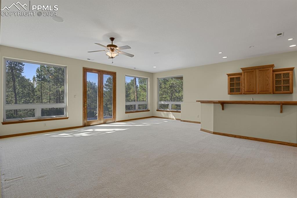 810 Dolan Drive Monument, CO 80132 - Photo 19 of 50 a view of a livingroom with a ceiling fan and window