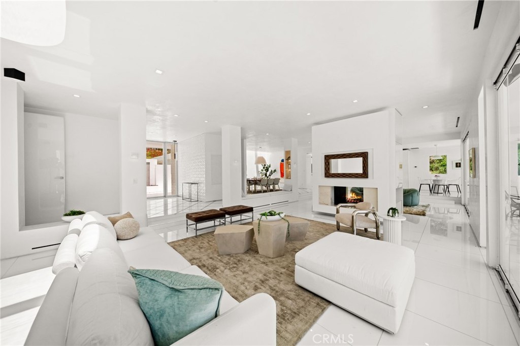 1046 North Hillcrest Road Beverly Hills, CA 90210 - Photo 16 of 74 a living room with furniture a rug and white walls