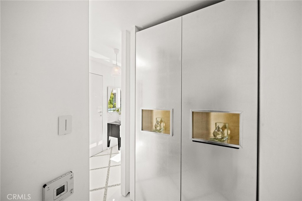 1046 North Hillcrest Road Beverly Hills, CA 90210 - Photo 37 of 74 a view of a hallway with workspace