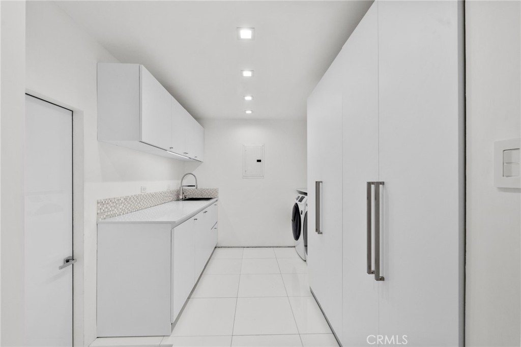 1046 North Hillcrest Road Beverly Hills, CA 90210 - Photo 49 of 74 a kitchen with white cabinets and refrigerator