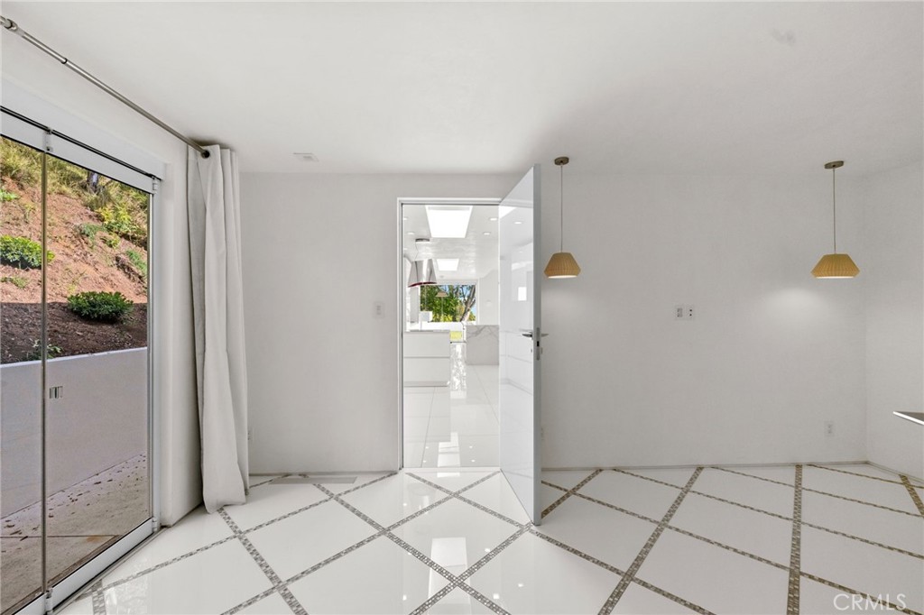 1046 North Hillcrest Road Beverly Hills, CA 90210 - Photo 55 of 74 a view of an empty room and window