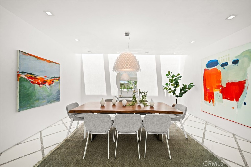 1046 North Hillcrest Road Beverly Hills, CA 90210 - Photo 10 of 74 a dining room with furniture and wooden floor