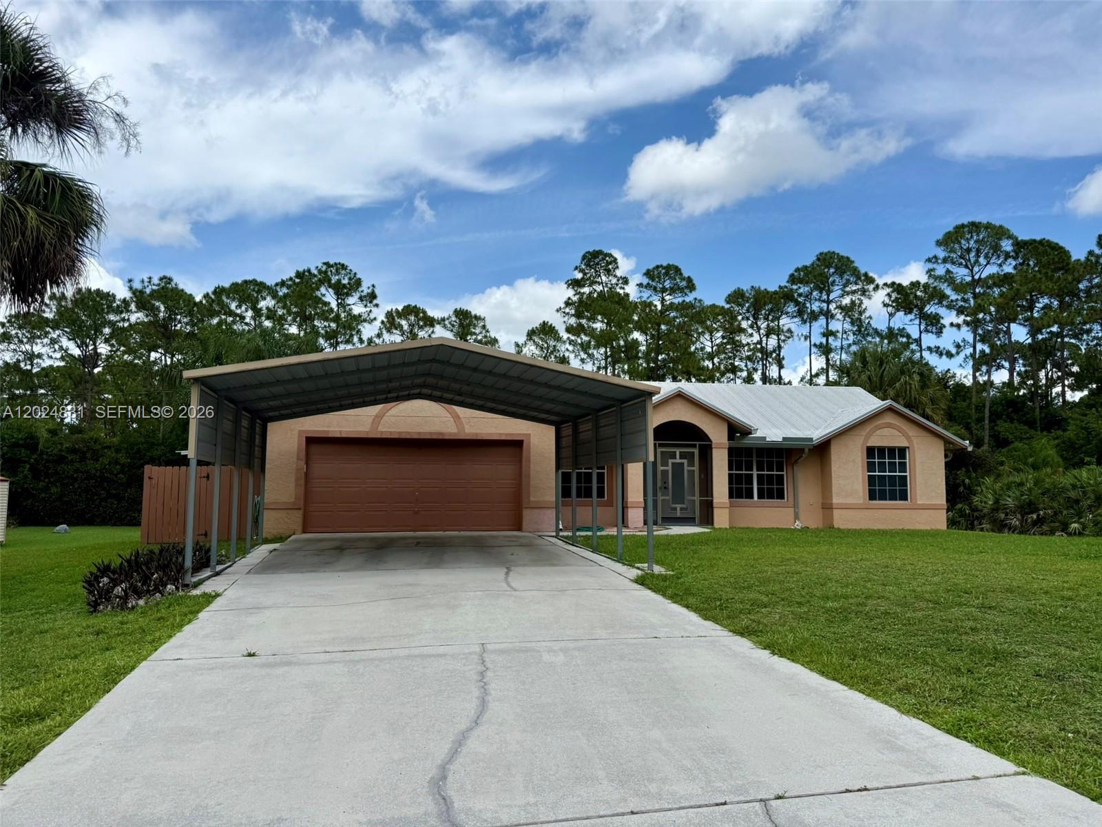 15819 76th Road North Loxahatchee, FL 33470 - Photo 2 of 45 a front view of a house with a garden