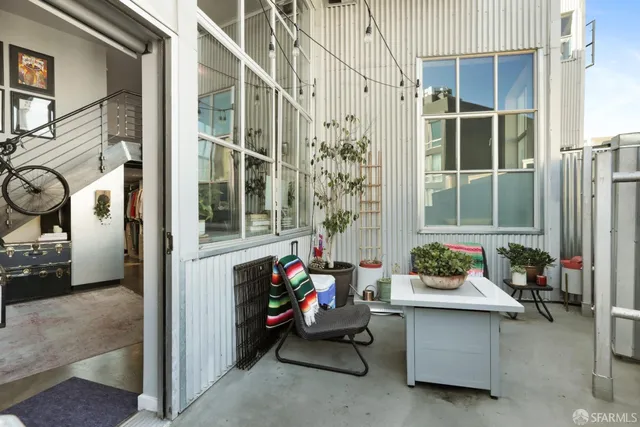 a living room filled with furniture and a potted plant