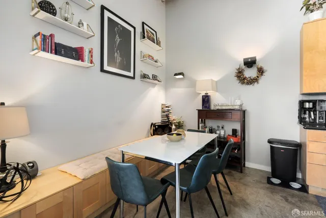 a kitchen with a table chairs stove and white cabinets