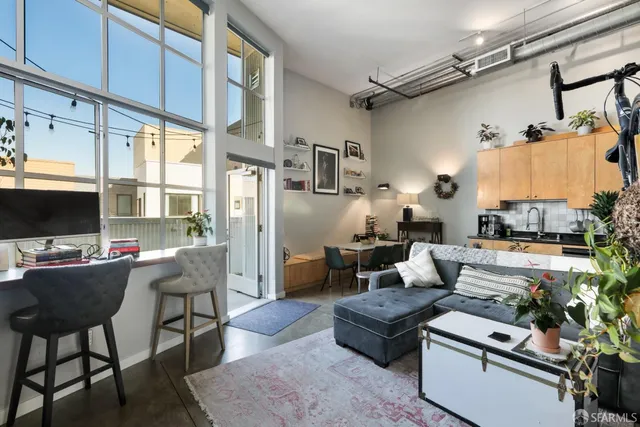 a walk in closet with clothes and shoes