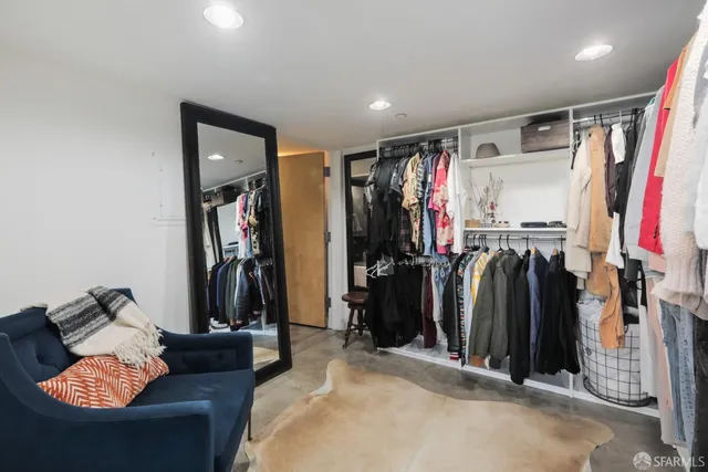 a hallway with furniture and a mirror