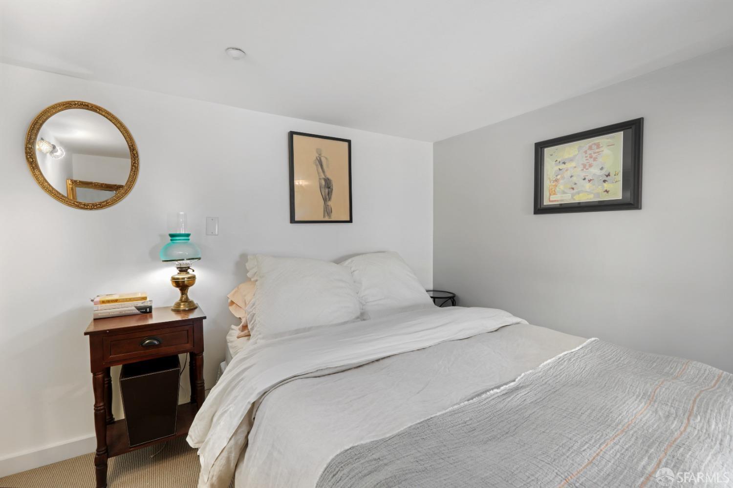 60 Rausch Street, Unit 303 San Francisco, CA 94103 - Photo 28 of 39 a bedroom with a bed and a mirror
