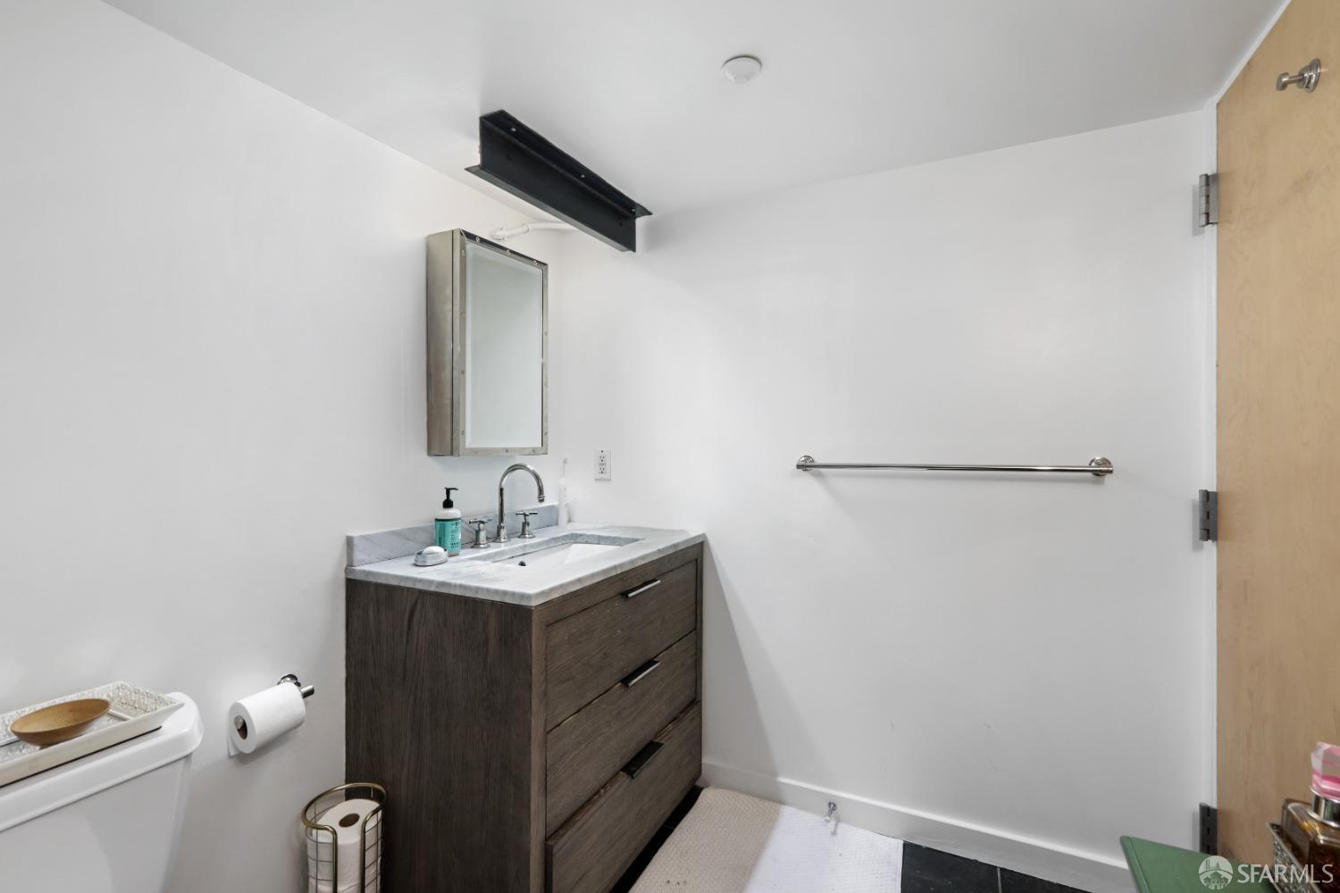 60 Rausch Street, Unit 303 San Francisco, CA 94103 - Photo 31 of 39 a bathroom with a sink toilet and mirror