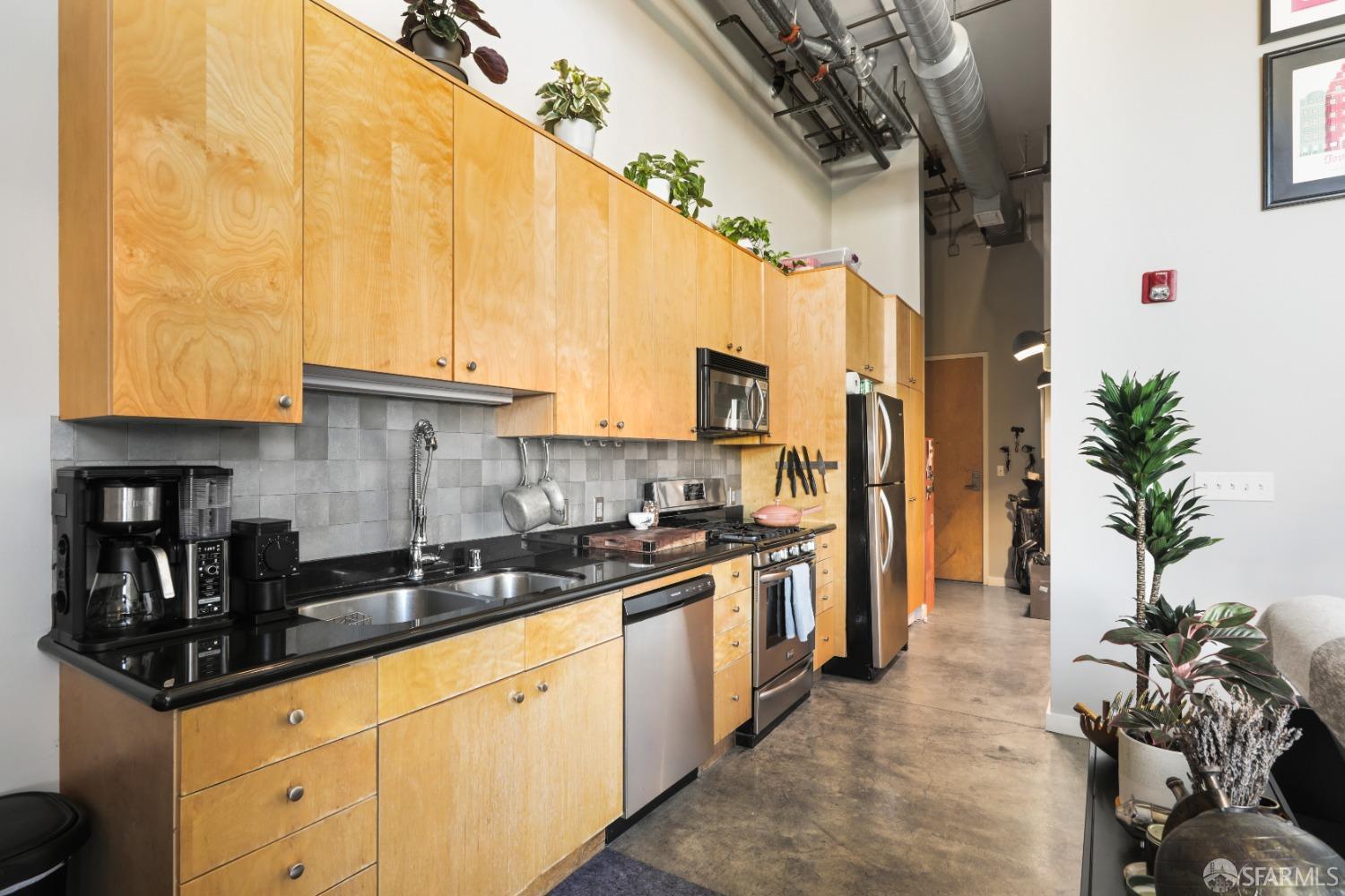 60 Rausch Street, Unit 303 San Francisco, CA 94103 - Photo 7 of 39 a kitchen with stainless steel appliances granite countertop a sink a stove and refrigerator