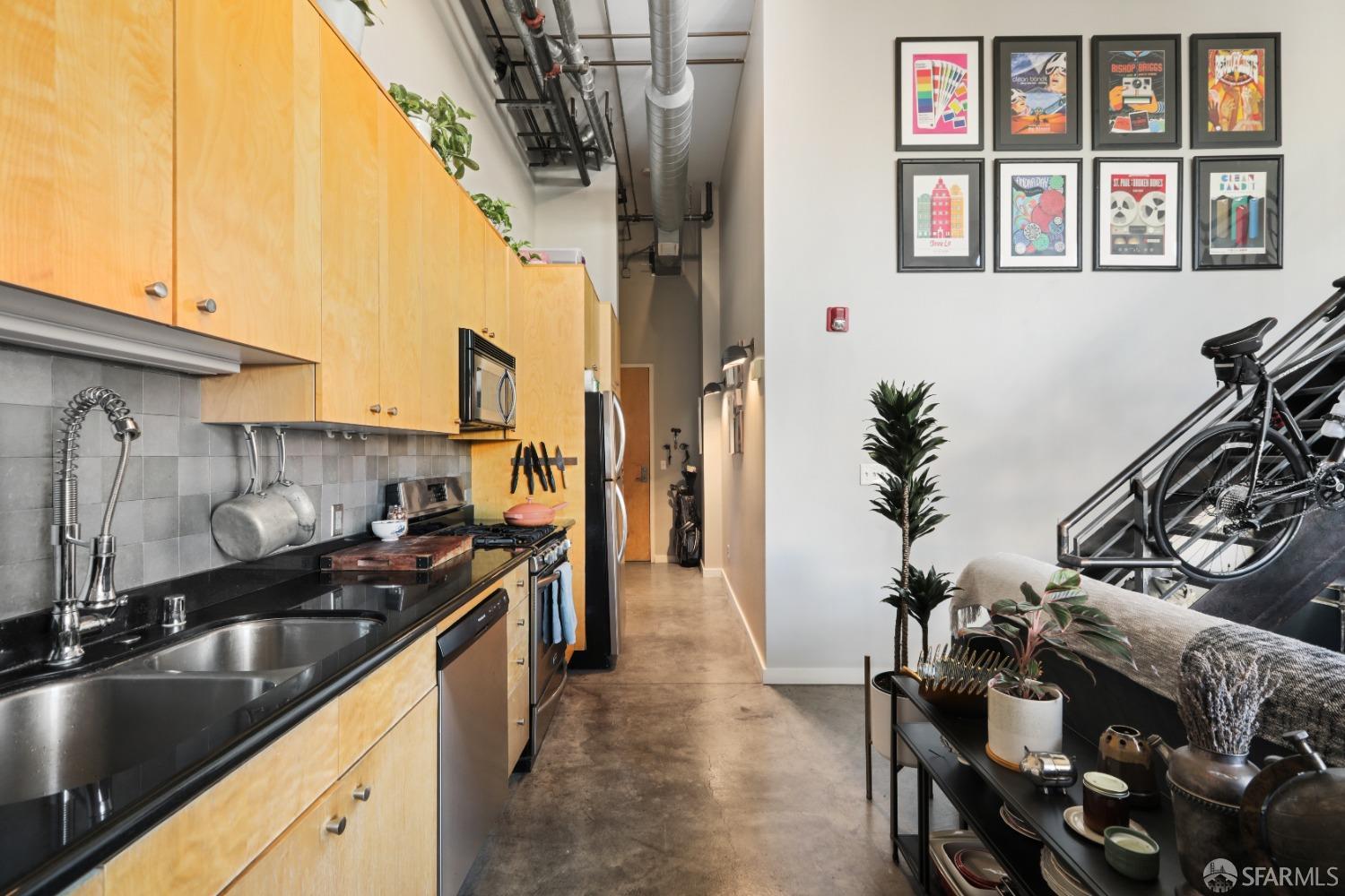 60 Rausch Street, Unit 303 San Francisco, CA 94103 - Photo 10 of 39 a kitchen with stainless steel appliances a sink stove and cabinets