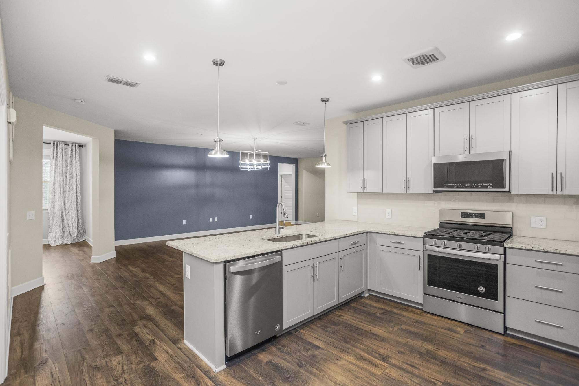 a kitchen with a sink stove and microwave