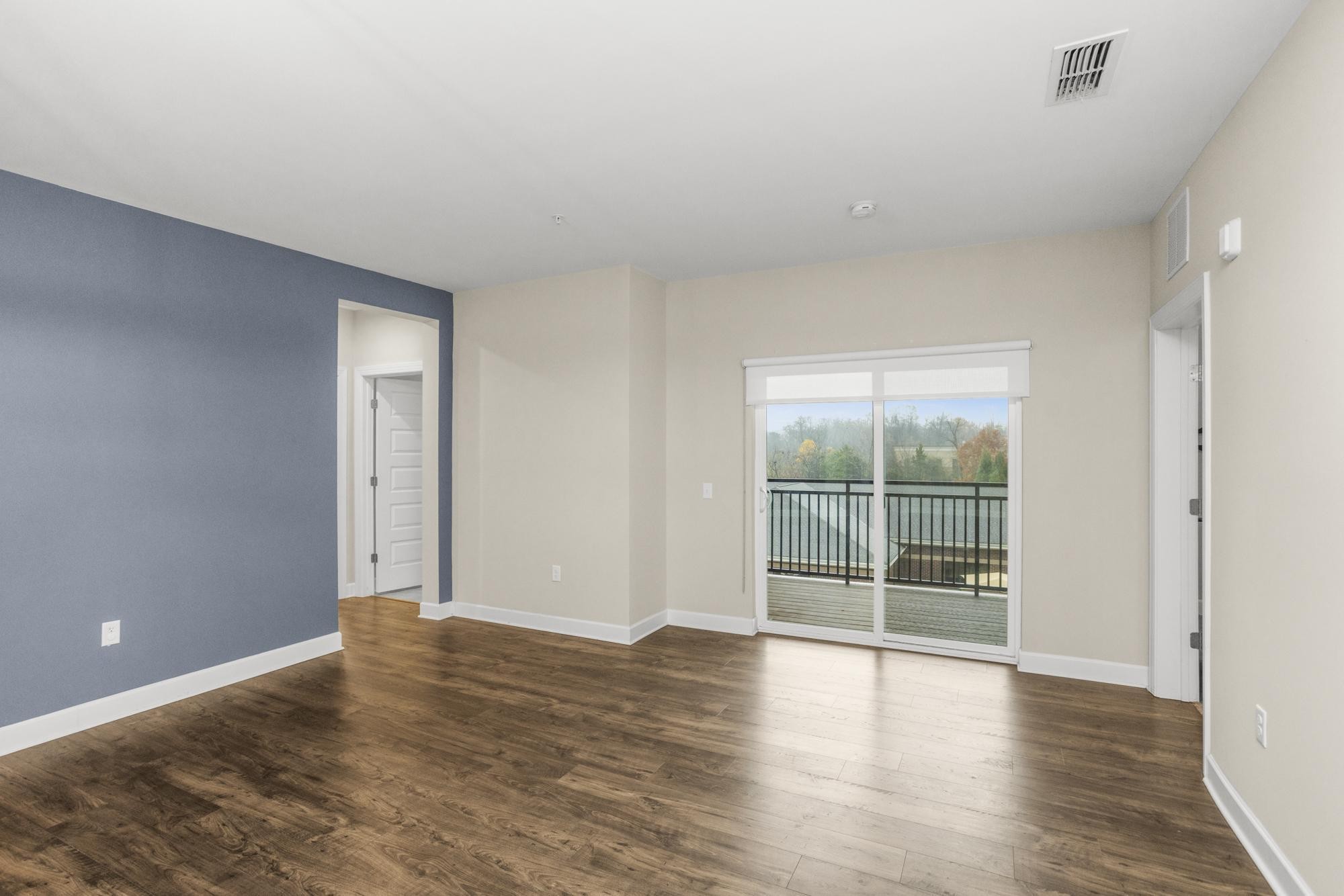 141 Saundersville Road, Unit 1402 Hendersonville, TN 37075 - Photo 13 of 60 a view of an empty room with wooden floor and a window