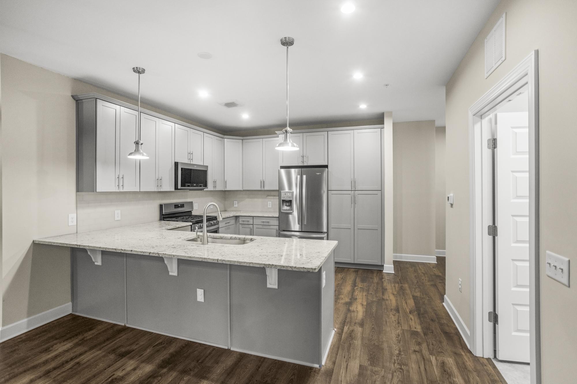 141 Saundersville Road, Unit 1402 Hendersonville, TN 37075 - Photo 3 of 60 a kitchen with stainless steel appliances granite countertop a sink refrigerator and cabinets