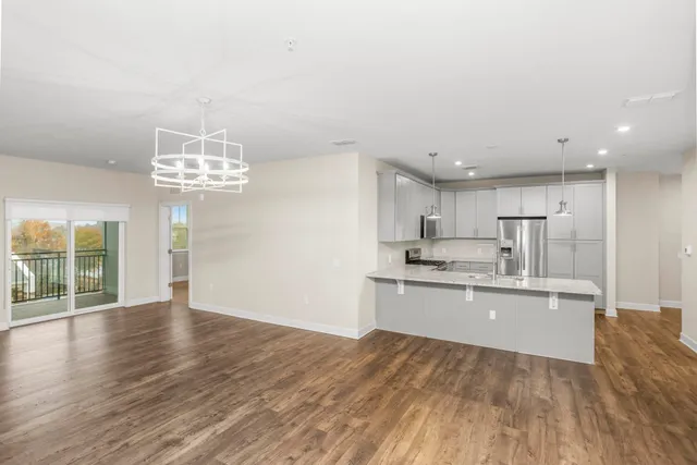 a living room with furniture a rug and a chandelier