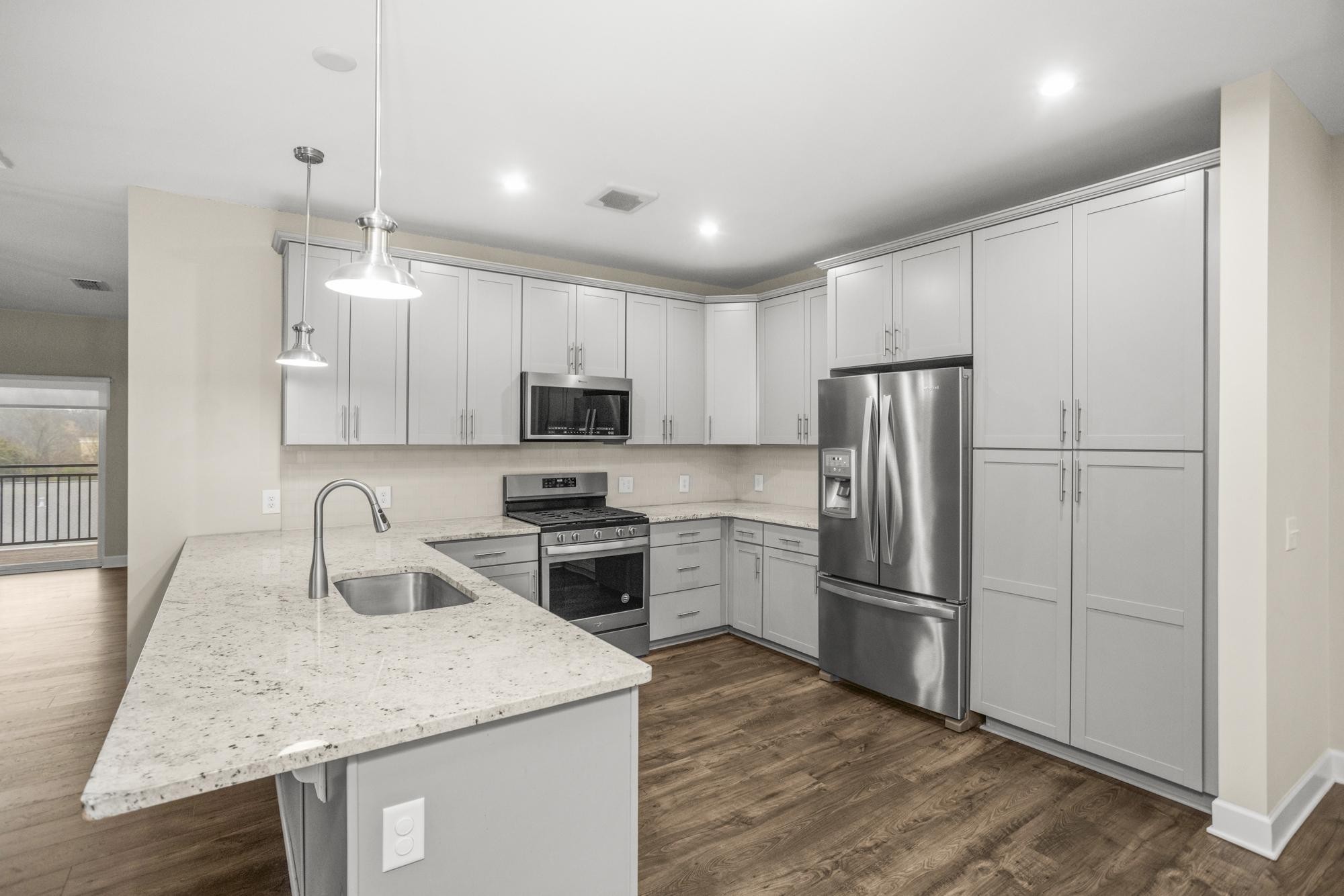 141 Saundersville Road, Unit 1402 Hendersonville, TN 37075 - Photo 4 of 60 a kitchen with kitchen island granite countertop appliances cabinets and a sink
