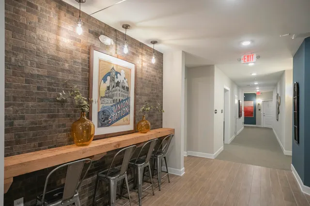 a front view of a multi story residential apartment building with yard and traffic signal
