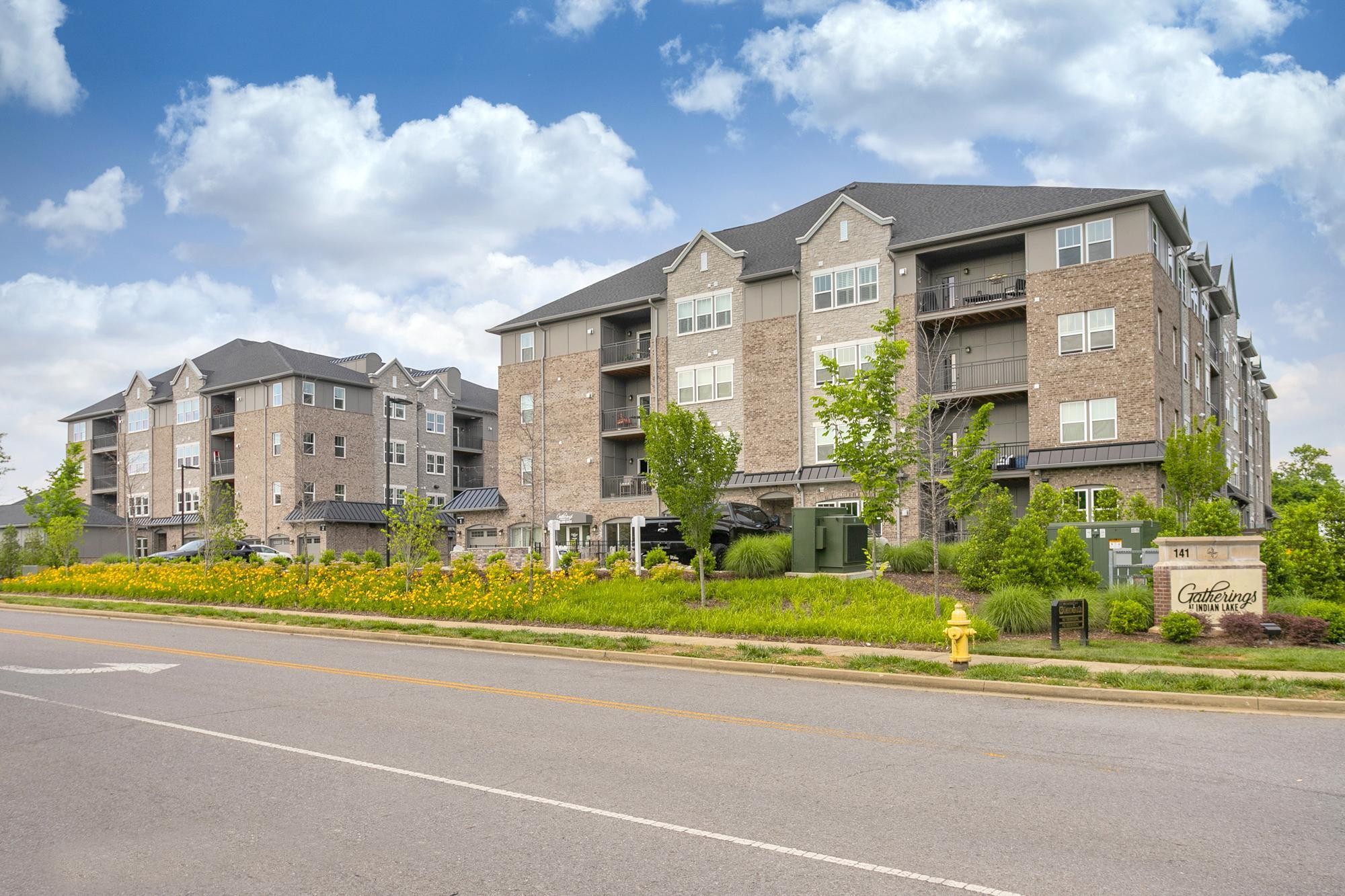 141 Saundersville Road, Unit 1402 Hendersonville, TN 37075 - Photo 60 of 60 a front view of a multi story residential apartment building with yard and traffic signal