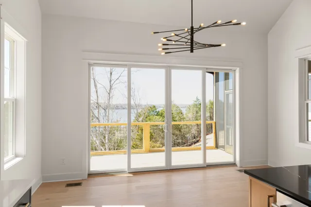 a kitchen with stainless steel appliances a sink a large window and wooden floor