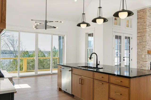 a kitchen with stainless steel appliances granite countertop a refrigerator and a stove