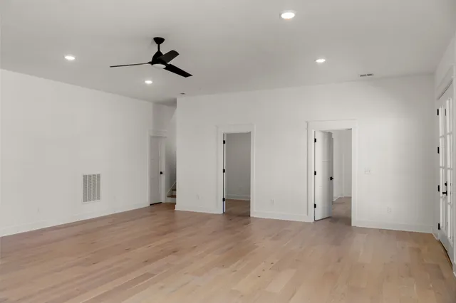 a view of a room with wooden floor and a sink