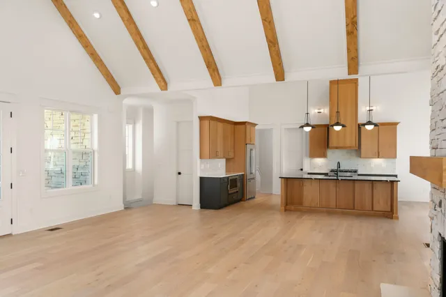 a large white kitchen with a large window