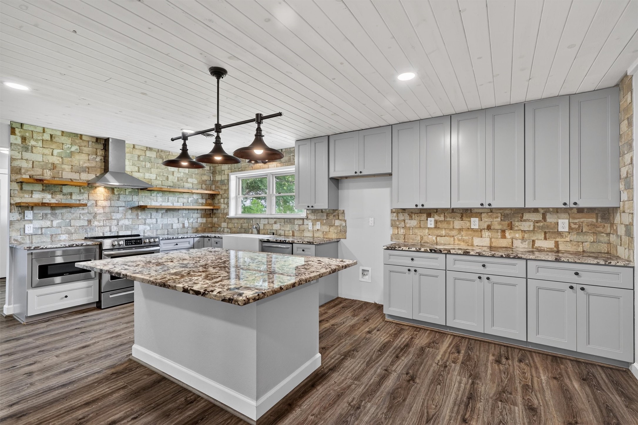 a kitchen with stainless steel appliances granite countertop a stove and a sink
