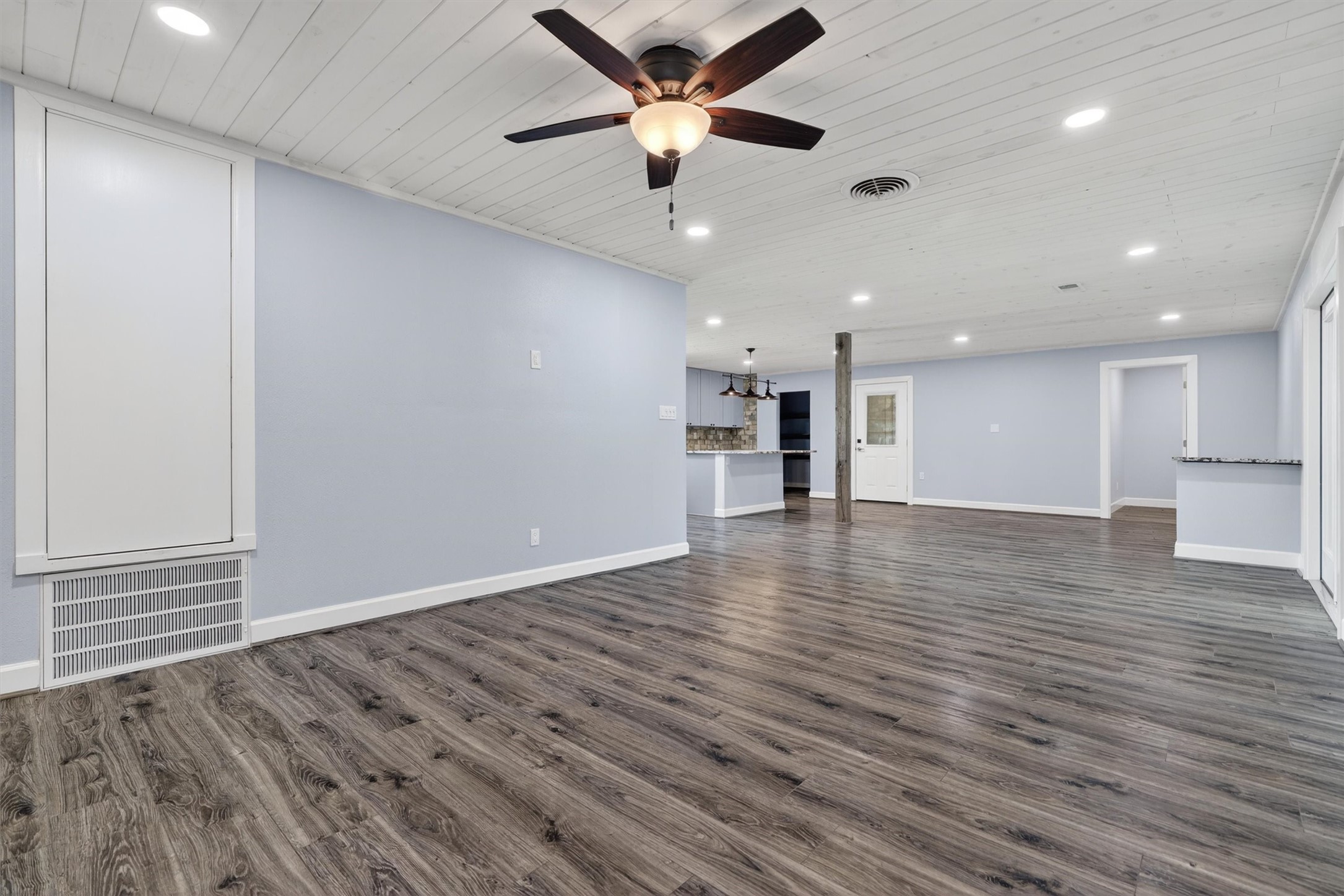 379 Hale Road Bay City, TX 77414 - Photo 11 of 28 a view of an empty room with a ceiling fan window and wooden floor